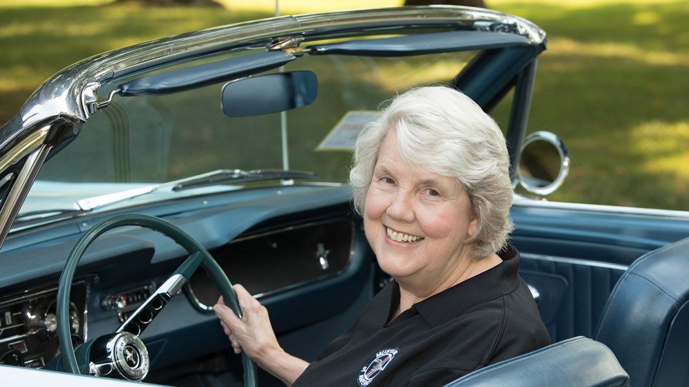 Gail Wise, first person to purchase a Ford Mustang, sits behind the wheel of her car.