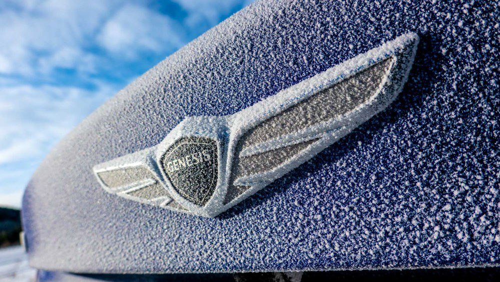 The Genesis G70 sedan being driven in snow.