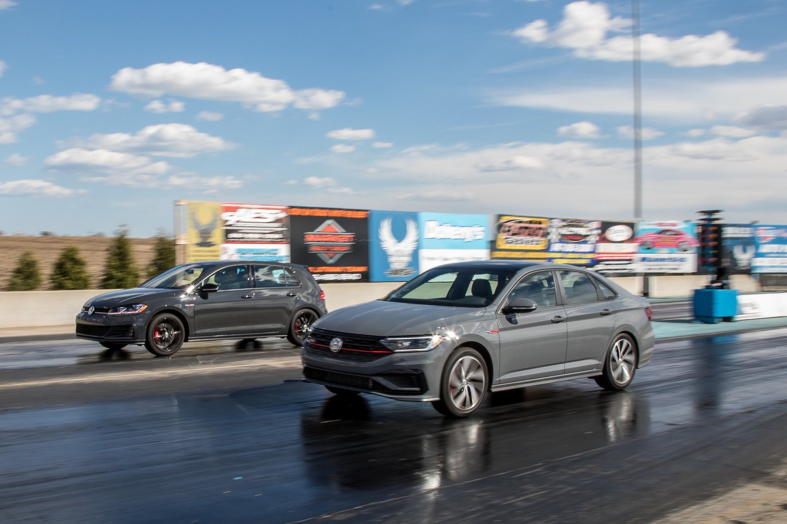 02-volkswagen-jetta-gli-and-golf-gti-2019-angle--drag-strip--dynamic--exterior--front--grey--head-to-head.jpg