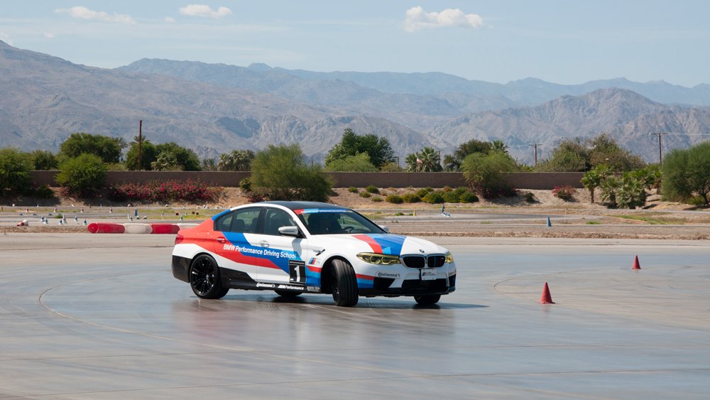 A BMW M5 drifting on the BMW Performance Center West's skid pad.