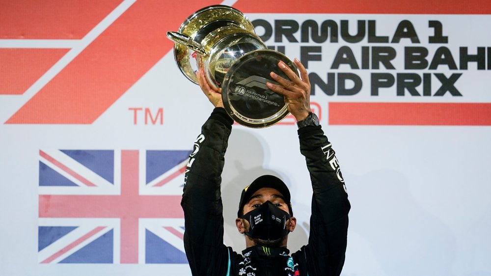 Lewis Hamilton holds the trophy high after his win in the Bahrain Grand Prix.