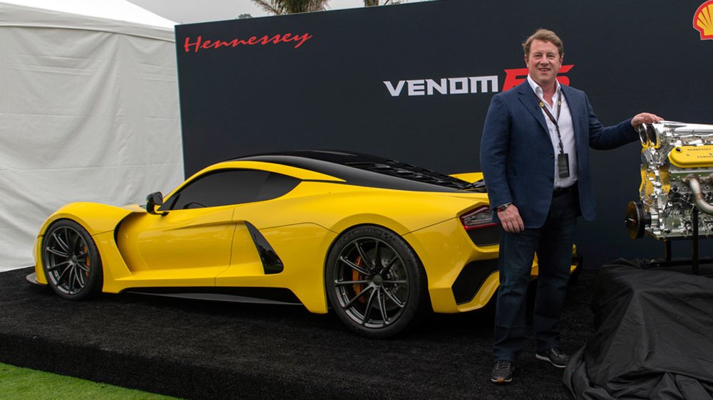 John Hennessey stands with his Venom F5 static prototype and newly developed engine at the Quail Motorsports Gathering in 2018.