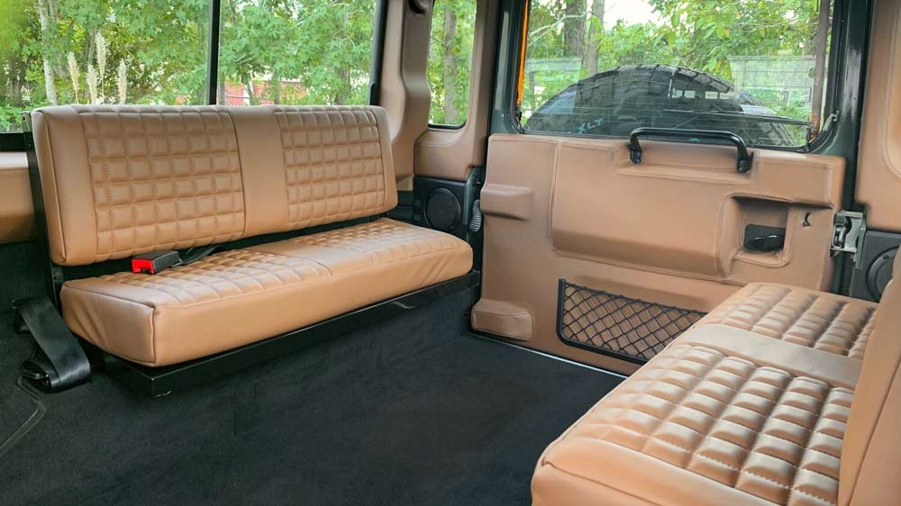 The rear interior of a restomod Land Rover Defender 110 from Osprey Custom Cars.