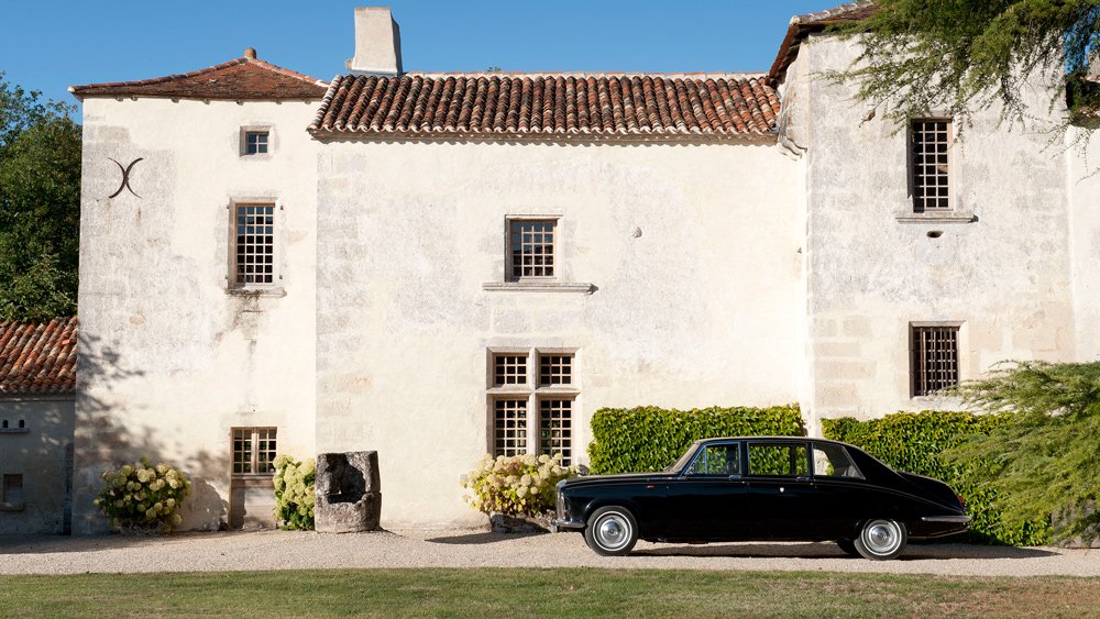 A Daimler DS 420 accents the Château de Puygaty in rural France.