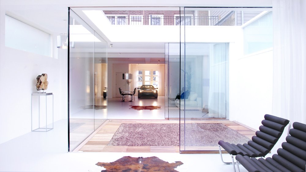 Once an old carpentry shed, this Netherlands home was transformed by Studio OxL and now houses a Tesla Roadster.