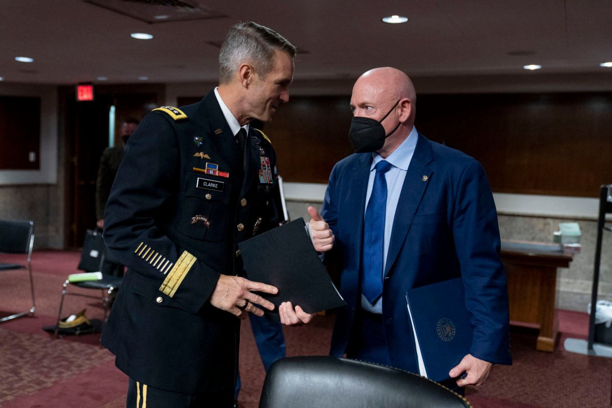 WASHINGTON, DC - MARCH 25: Special Operations Command Gen. Richard Clarke, left, and Sen. Mark Kelly (D-AZ), right, speak following a hearing to examine United States Special Operations Command and United States Cyber Command in review of the Defense Authorization Request for fiscal year 2022 and the Future Years Defense Program, on Capitol Hill on March 25, 2021 in Washington, DC. Andrew Harnik-Pool/Getty Images/AFP (Photo by POOL / GETTY IMAGES NORTH AMERICA / Getty Images via AFP)