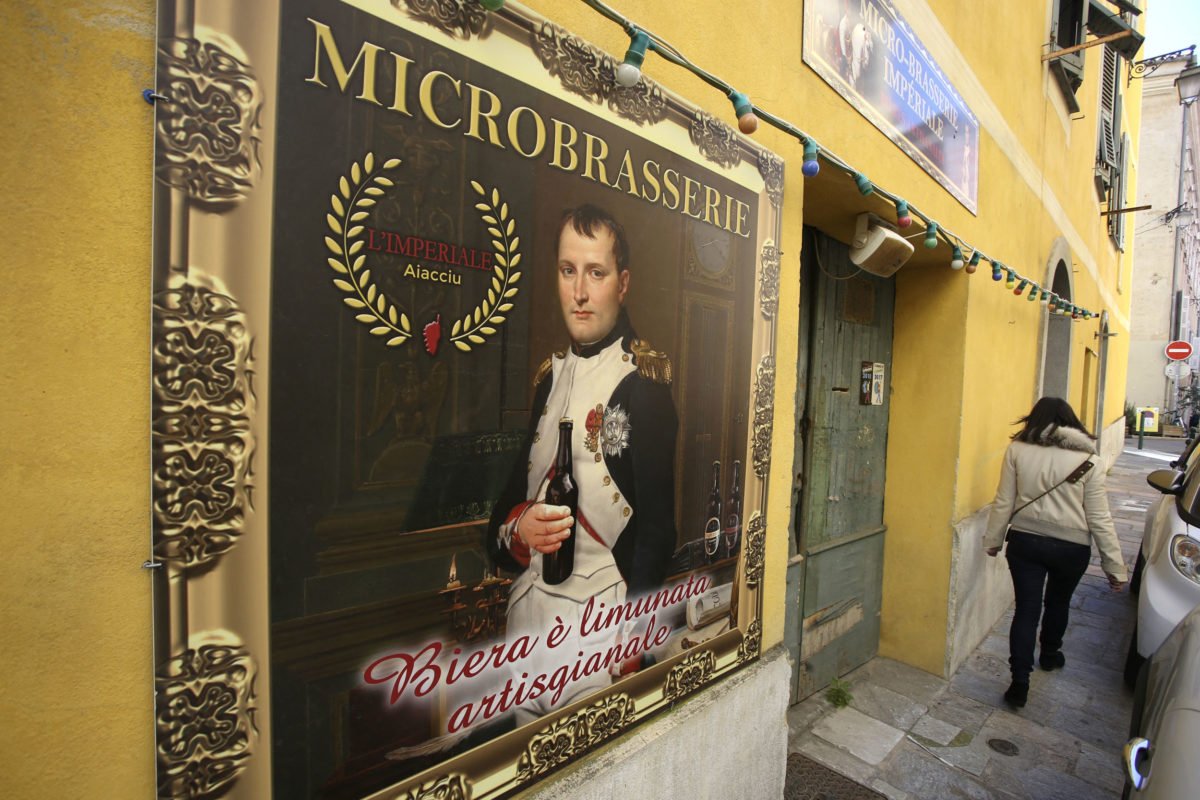 A woman walks by the Imperial beer Microbrasserie in Ajaccio on March 25, 2021 ahead of the 200th anniversary of the death of Napoleon Bonaparte on May 5, 2021, on the French mediterranean island of Corsica. (Photo by Pascal POCHARD-CASABIANCA / AFP)