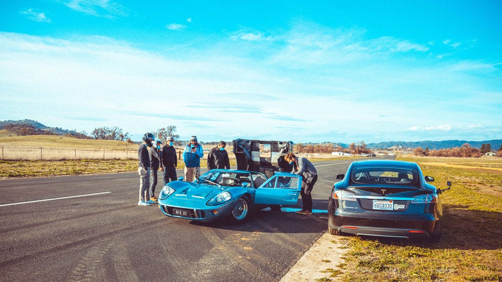 A 1967 Ford GT40 Mark III having issues with a coolant line after racing against a Tesla Model S.