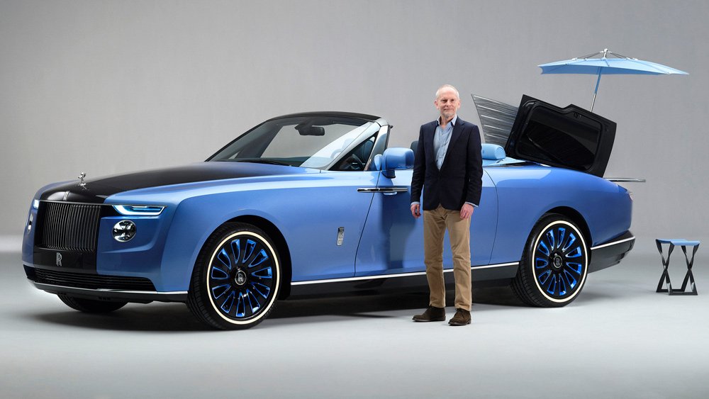 Automotive journalist Jeremy Taylor stands next to the 19-foot Rolls-Royce Boat Tail.