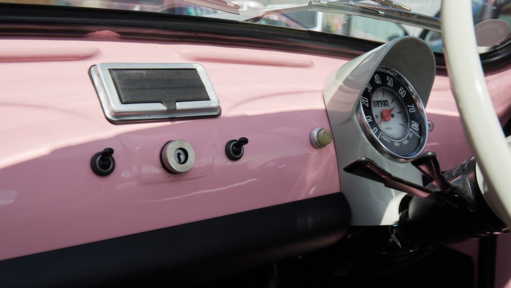 An interior close-up of an immaculately restored 1974 Fiat Cinquecento.