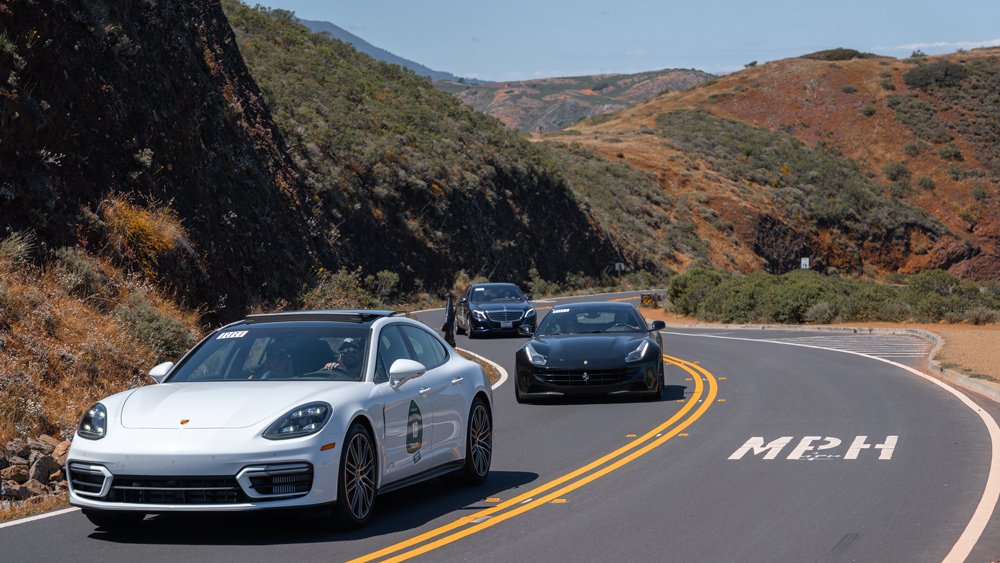 Cars in a road rally on Pacific Coast Highway.