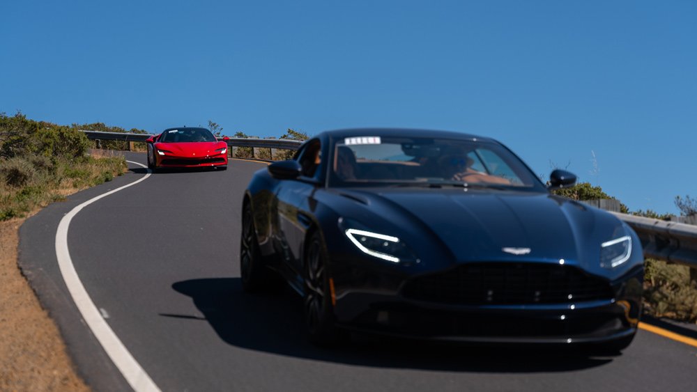 An Aston Martin and Ferrari take part in Robb Report's 2021 California Coastal road rally.
