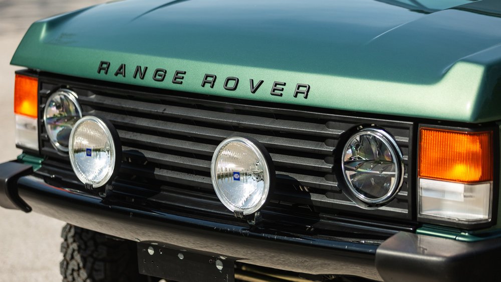 A closeup of the front of a 1991 Range Rover Classic restomod.
