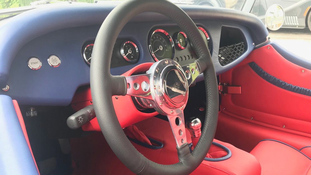 The steering wheel and dash of a 2019 Morgan Plus 4.