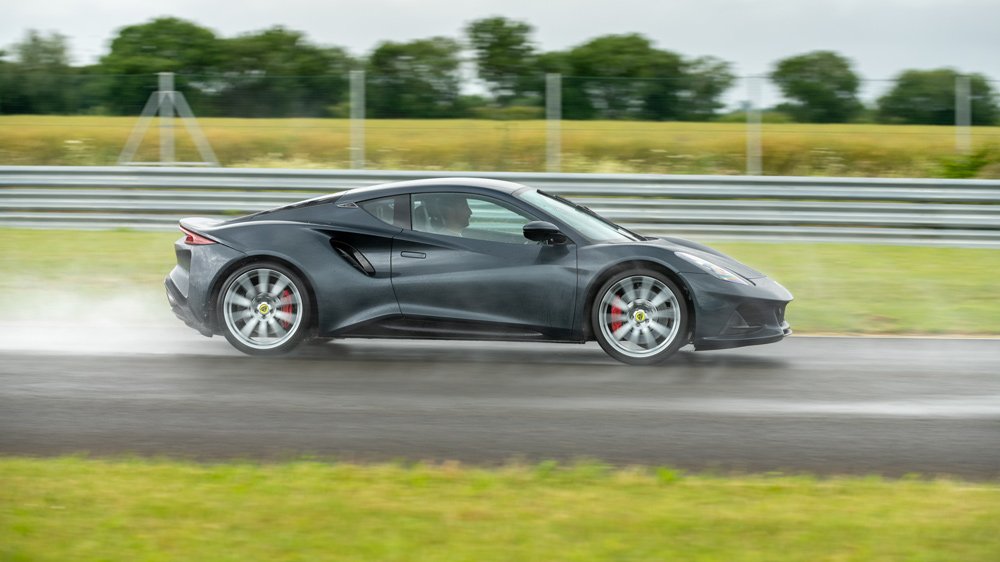 Racer Jenson Button testing the Lotus Emira on track.