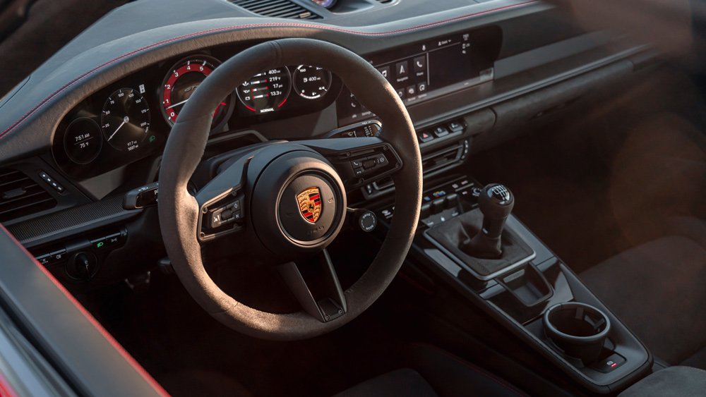The steering wheel and dash of a 2022 Porsche 911 GTS.