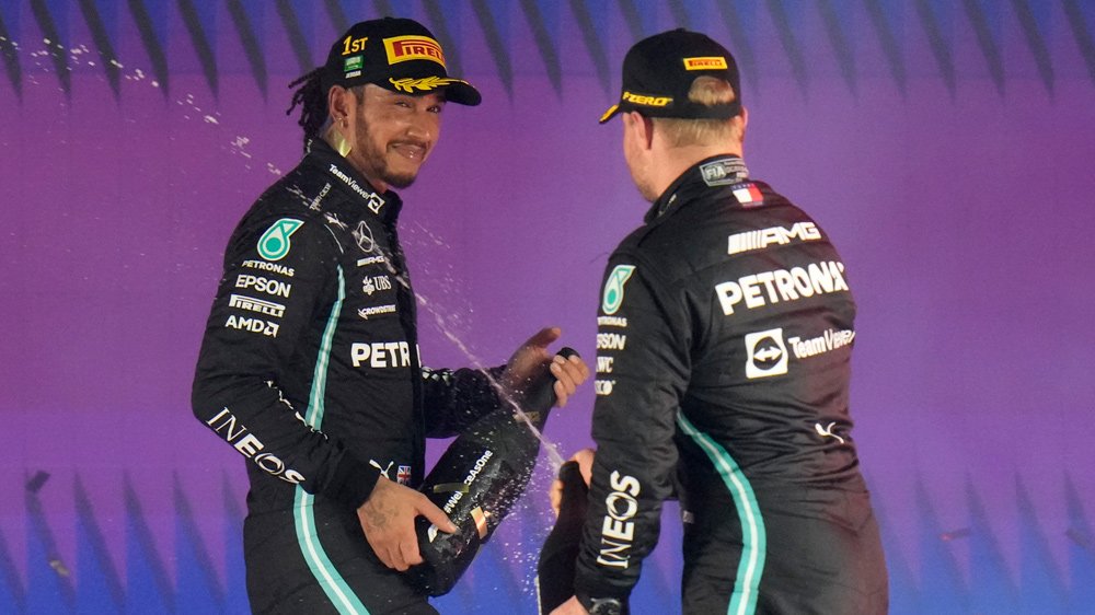 Lewis Hamilton and teammate Valtteri Bottas celebrate after the 2021 Saudi Arabian Grand Prix.