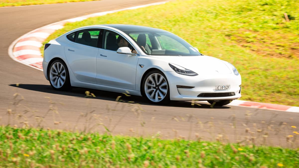 Drive Car of the Year Best Electric Vehicle 2021 finalist Tesla Model 3 driven on winding road as viewed from right side
