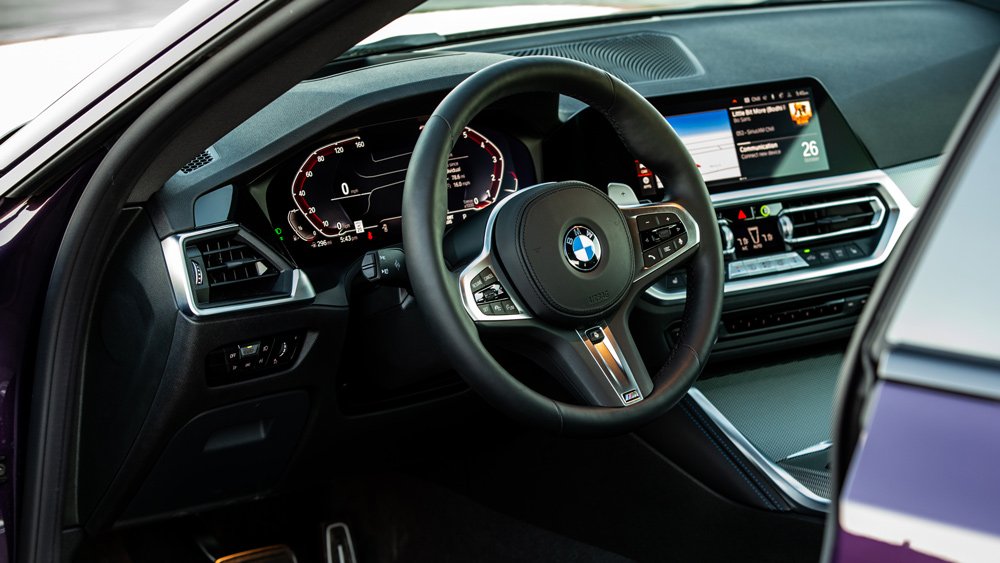 The steering wheel and dash of the 2022 BMW M240i xDrive.