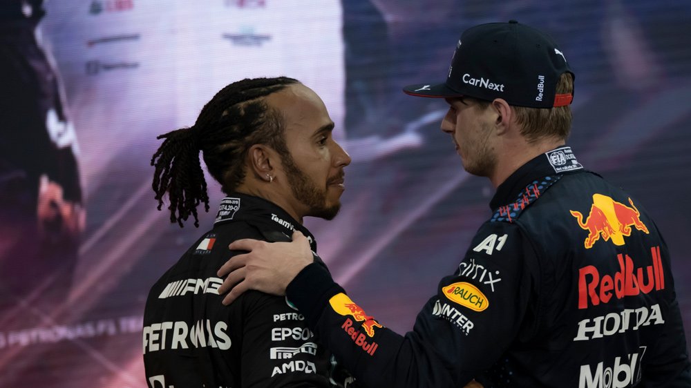 Lewis Hamilton (left) congratulates Max Verstappen (right) on winning the 2021 World Drivers' Championship title after the 2021 Abu Dhabi Grand Prix.