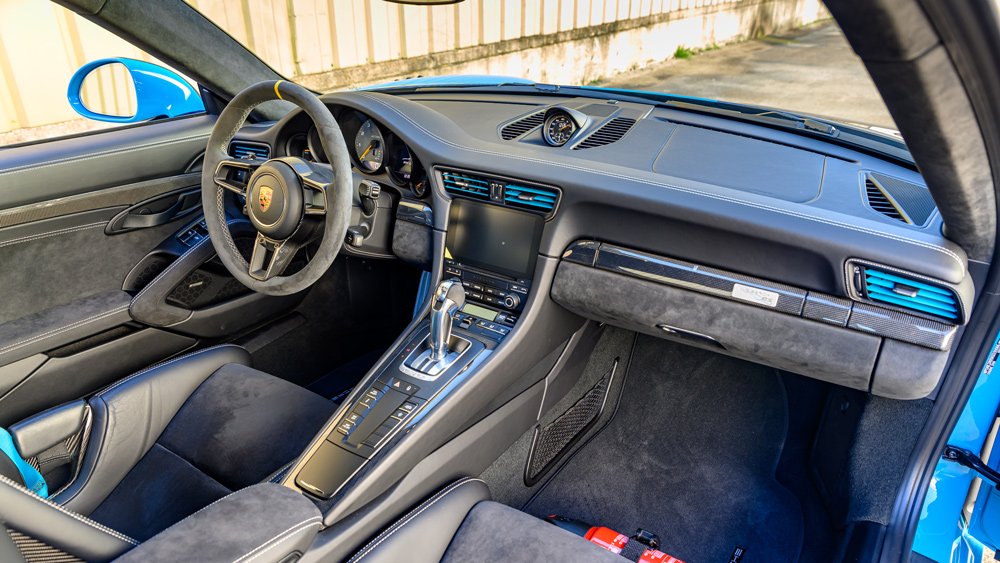 The interior of a 2019 Porsche 911 GT2 RS in Miami Blue.