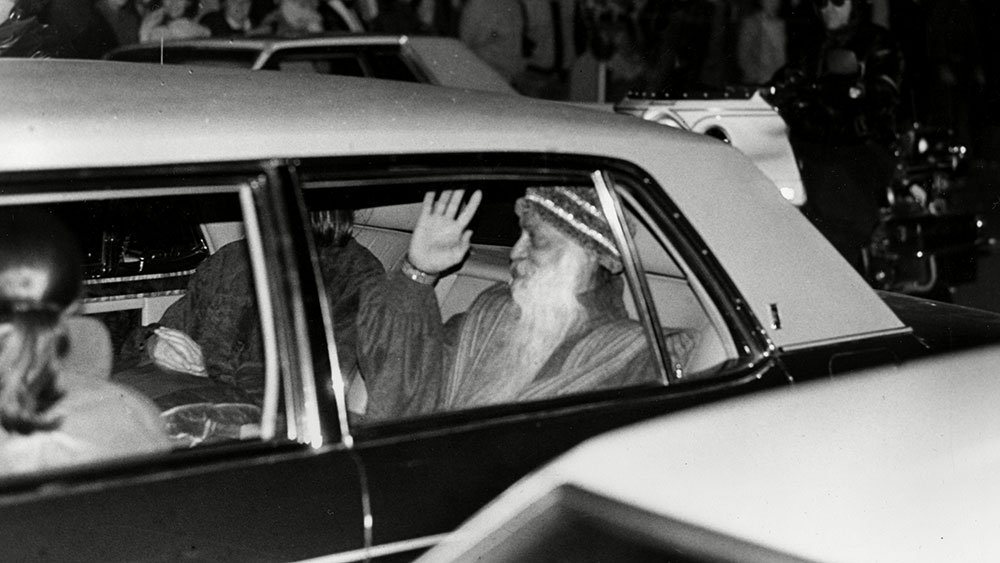 Rajneesh Indian guru Bhagwan Shree Rajneesh waves to the crowd from the backseat of his Rolls-Royce limousine after plea bargaining in Portland, Ore., federal court on two federal immigration charges, . Rajneesh changed his plea to guilty, received a 10-year suspended prison sentence, was fined $400,000 and agreed to leave the countryU.S. DEPORTATION RAJNEESH, PORTLAND, USA