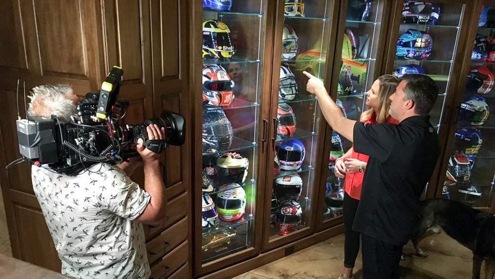 Shannon Spake, host of FS1’s RaceHub, being given a tour of Tony Stewart's helmet collection by Stewart himself.