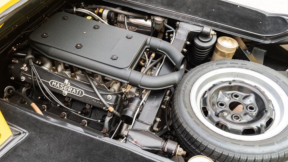 The engine and spare tire inside a 1975 Maserati Bora.
