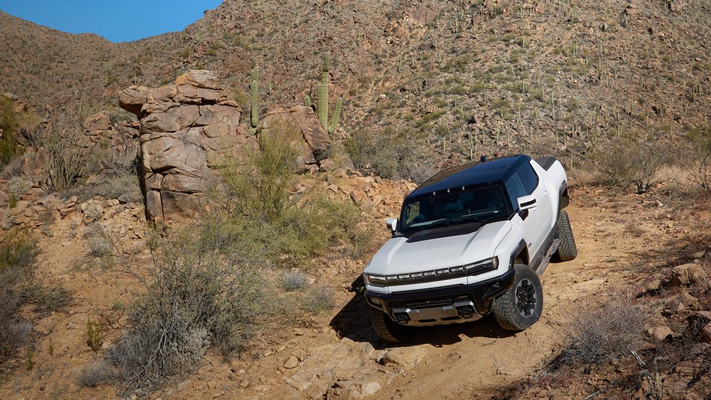 The 2022 Hummer EV Pickup being driven off-road.