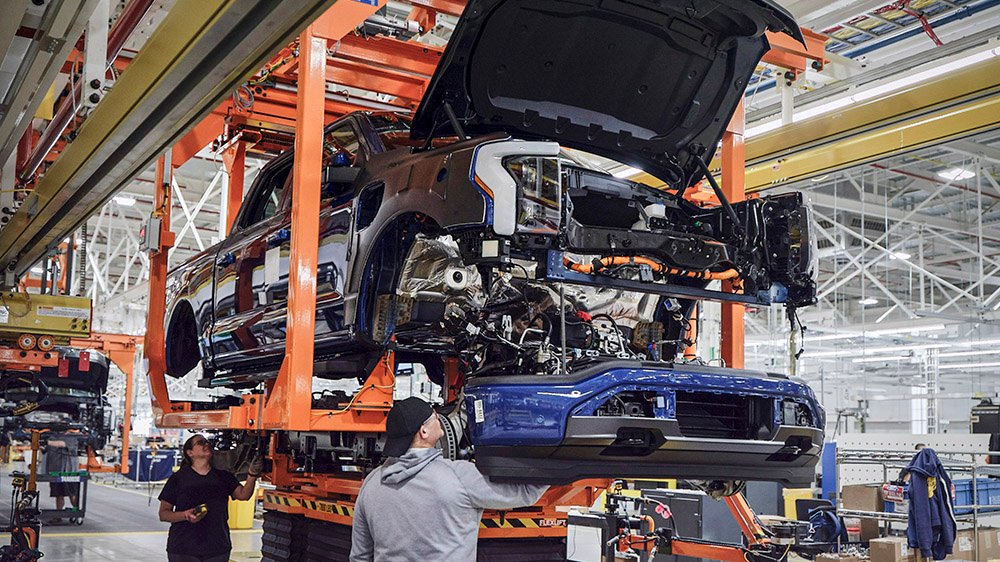 Workers build a F-150 Lightning at the company's Rouge Electric Vehicle Center in Dearborn, Michigan