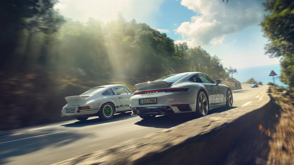A 2023 Porsche 911 Sport Classic (right) driven alongside a 1970's-era 911 Carrera RS 2.7.