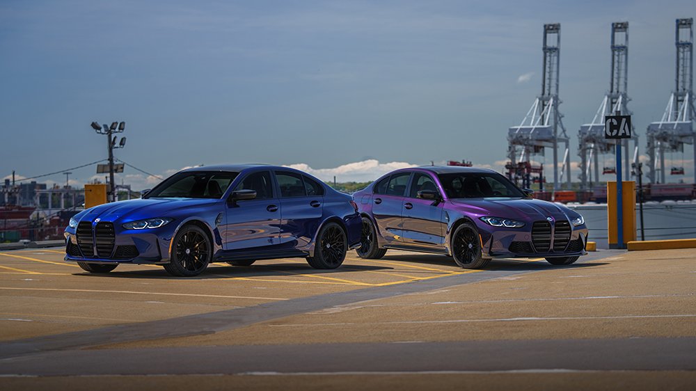 The 2023 The M3 Edition 50 Jahre BMW M in Deep Interlagos Blue in front of another example in Techno Violet