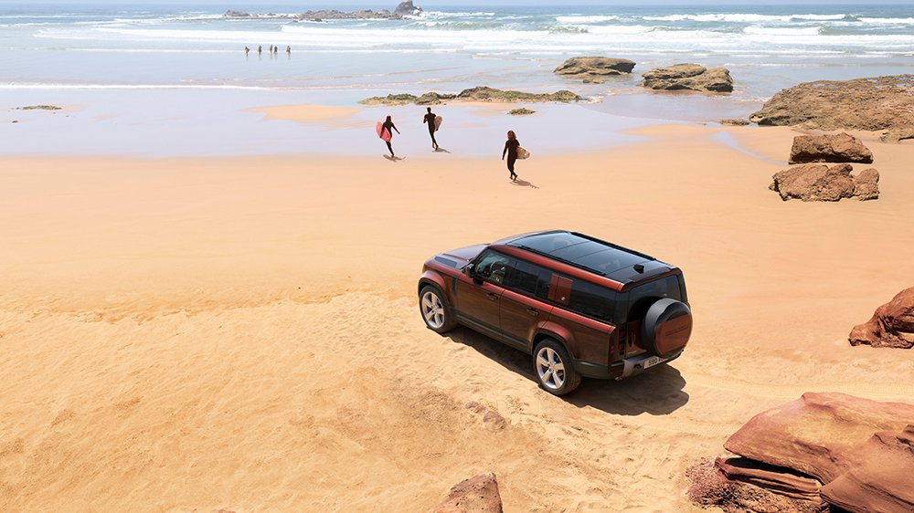 The 2023 Land Rover Defender 130 parked on a beach
