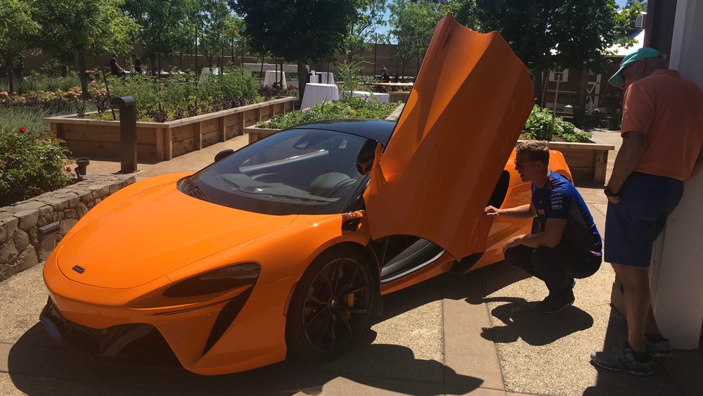 At the Carneros Resort and Spa in Napa, a McLaren rep guides a guest through the McLaren Artura hybrid model.