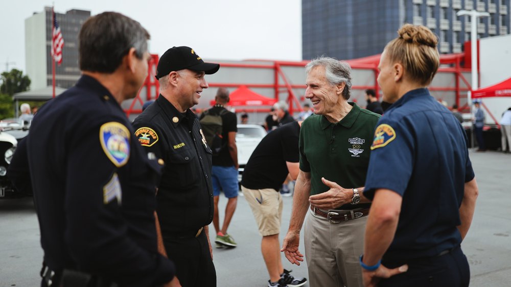 Bruce Meyer, co-founder of the Rodeo Drive Concours d'Elegance, chats with Beverly Hills police officers.