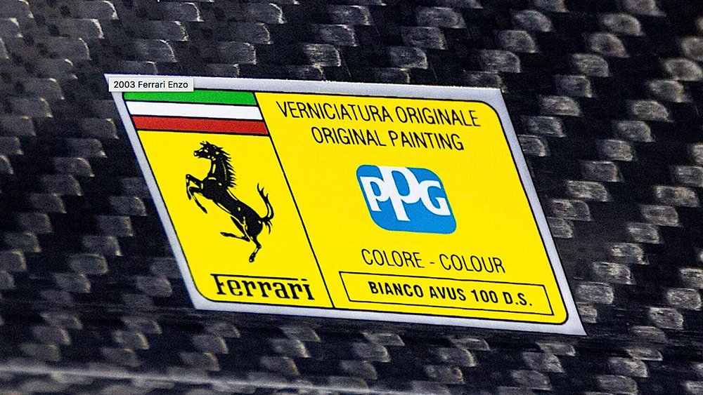 Official badging that certifies Bianco Avus as the color this Ferrari Enzo was painted at the factory.