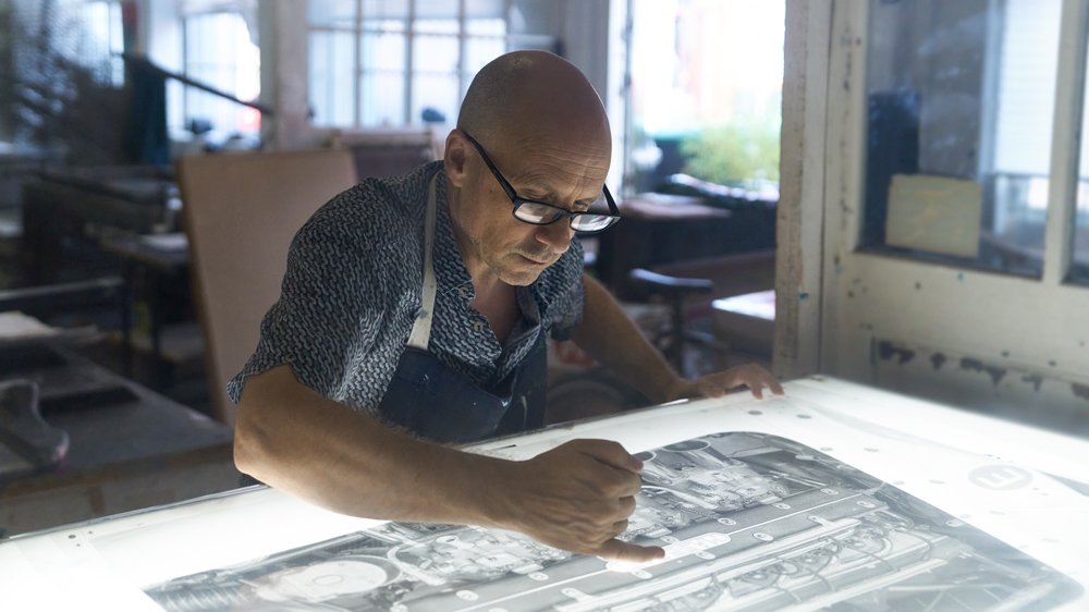 Artist Alan Thornton creating a silk-screen print.