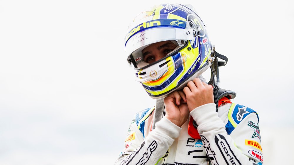 Racer Lando Norris dons his helmet at Autodromo Nazionale di Monza for round 10 of the Formula 2 series in 2018.