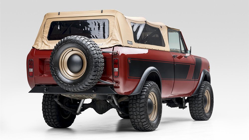 A rear 3/4 view of the 1977 International Harvester Scout II Traveler with its tan soft-top attached