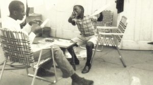 An eight-year-old Donald Osborne building a model of the Lotus 29 race car with his older brother.