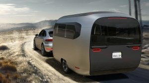 The Airstream Studio F.A. Porsche Concept Travel Trailer being towed by a Porsche Cayenne