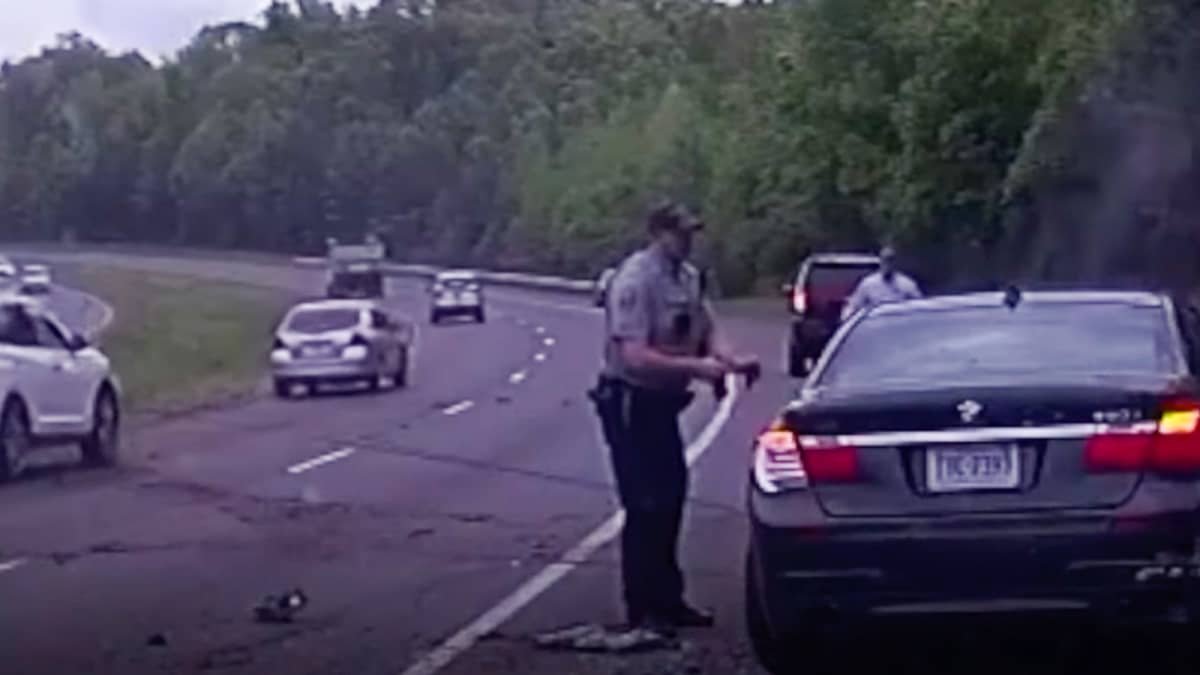 Video: Shocking footage shows police officer narrowly escape roadside collision
