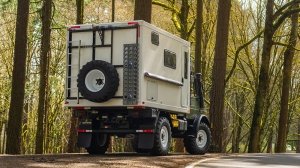 A rear 3/4 view of the 1987 Mercedes-Benz Unimog U1300L camper conversion