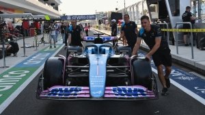 Alpine team members get Esteban Ocon's car ready for racing at the 2023 Miami Grand Prix.