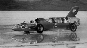 Despite four inches of water on the ground, Paula Murphy pilots the Avenger jet car to 243.33 mph at the Bonneville Salt Flats in 1965.