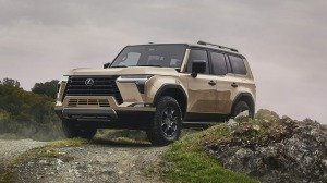 The 2024 Lexus GX 550 Overtrail+ climbing over a hill