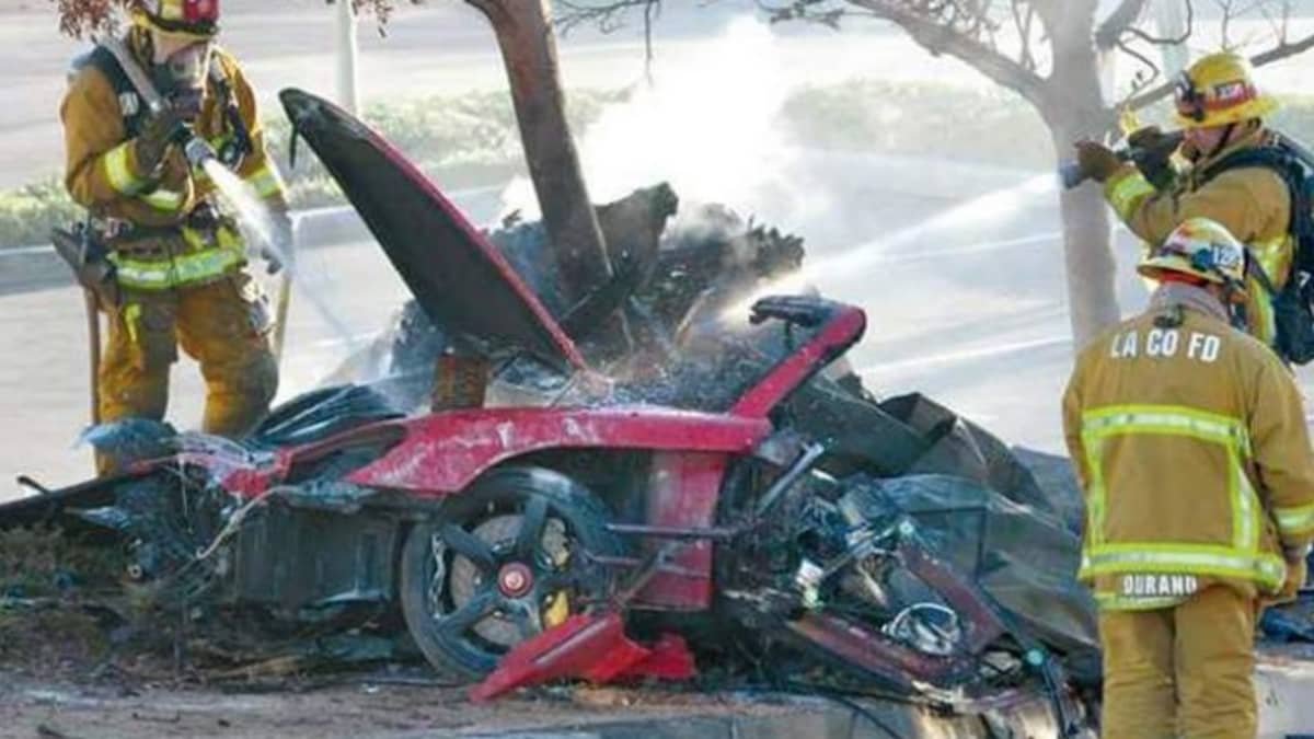 Firefighters extinguish the fire after the crash which killed film star Paul Walker.