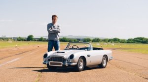 Automotive journalist Tim Pitt stands beside the Little Car Company's DB5 Junior 