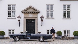 Anders Kirk Johansen with his 1967 Lincoln Continental convertible and his Old Danish Pointer, Pippi, outside the main house at his estate, Rohden Gods