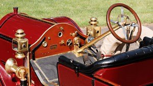 A close-up of the steering wheel and dashboard in a 1912 Simplex 50 HP Toy-Tonneau.